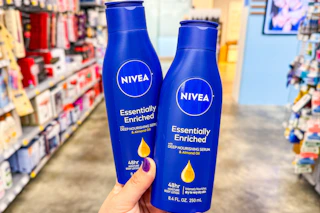 person holding 2 nivea lotions in an aisle