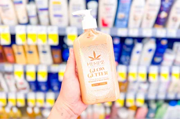 hand holding a bottle of hempz lotion in a store aisle
