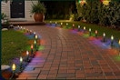 Brightown Christmas Pathway Lights Outdoor, 25.7 Feet C9 Lights with 20 Multicolor lighting a sidewalk.