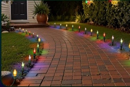 Brightown Christmas Pathway Lights Outdoor, 25.7 Feet C9 Lights with 20 Multicolor lighting a sidewalk.