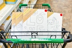 dollar tree canvases in a shopping cart