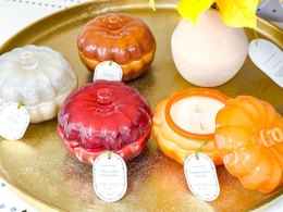 4 threshold pumpkin glass candles together on a tray