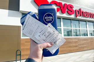 hand holding nivea men body wash and a cvs extrabucks receipt