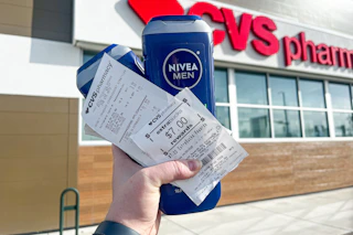 hand holding nivea men body wash and a cvs extrabucks receipt