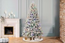 Lifestyle image of the Holiday Time 6.5-foot Pre-Lit Flocked Artificial Christmas Tree in home setting