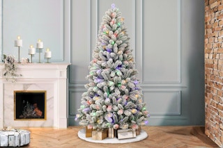 Lifestyle image of the Holiday Time 6.5-foot Pre-Lit Flocked Artificial Christmas Tree in home setting