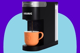 Keurig K-Slim Single Serve K-Cup Pod Coffee Maker on a blue background.