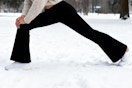 women wearing legging while stretching in snow