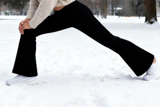 women wearing legging while stretching in snow