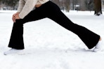 women wearing legging while stretching in snow