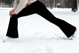 women wearing legging while stretching in snow