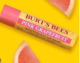 a yellow and pink tube of lip balm 