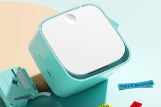 a teal and white label maker and colorful labels on a light blue and beige background