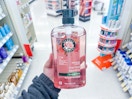hand holding herbal essences in walgreens