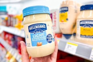 hand holding hellman's light mayonnaise in a store