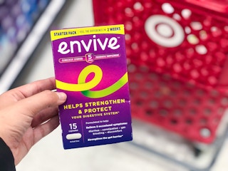 hand holding envive in front of target cart