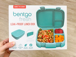 A person's hand holding a Bentgo Fresh lunch box at Kohl's.