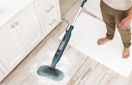 a person using a steam mop
