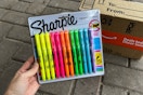 Sharpie highlighter being held in front of Prime box