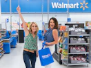 two people smiling inside of a walmart