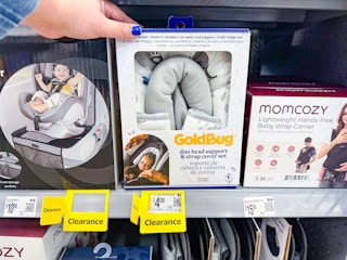 hand holding goldbug head support on walmart shelf