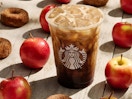 a Starbucks apple crisp oatmeal shaken espresso drink set against a background of apples and donuts