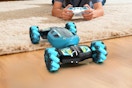 JSDOOGOO Gesture Sensing RC Stunt Car being used by a kid on the floor.