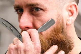 a man using a straight razor