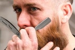 a man using a straight razor