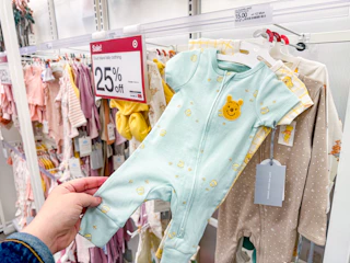 hand holding cloud island baby apparel at target