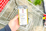 hand holding a smartphone displaying a 1-clip deal in the kcl app