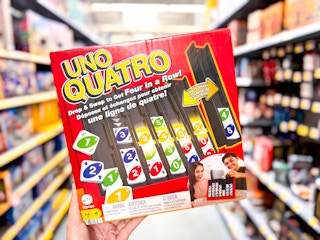 hand holding the Uno Quatro games in the toy aisle