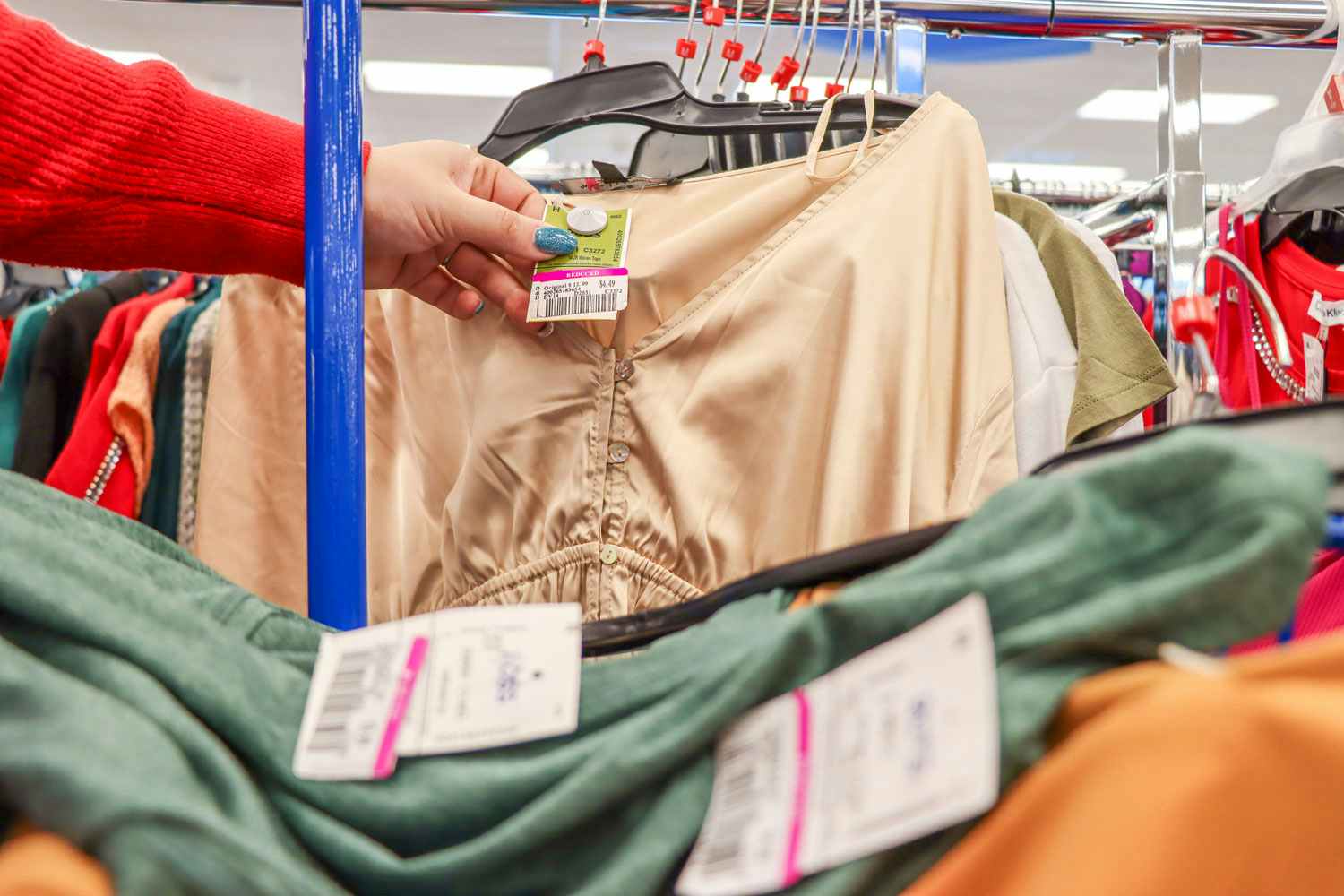 a person holding up a pink tag at ross