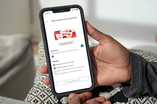 person holding iphone with yoplait saved offer in ibotta app