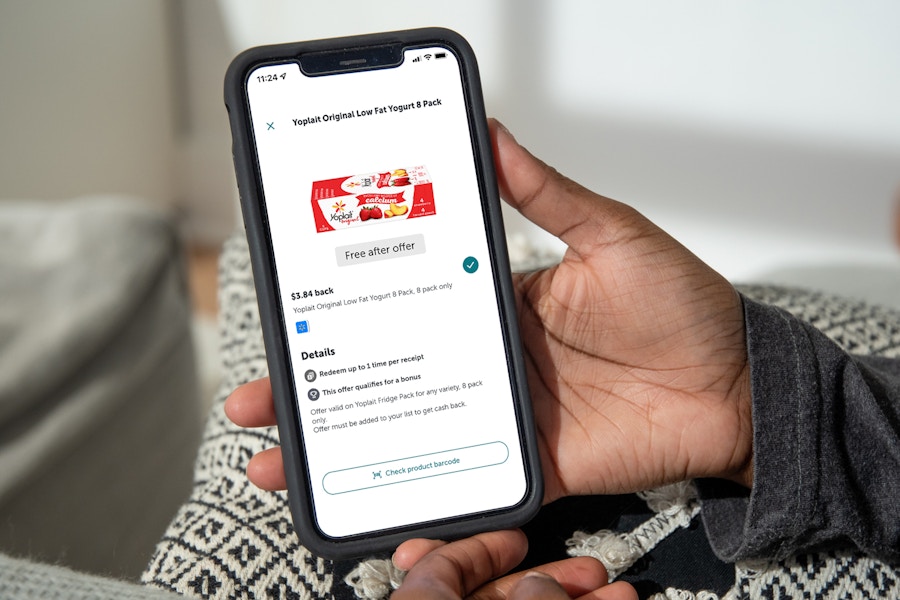 person holding iphone with yoplait saved offer in ibotta app
