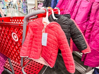 cat & jack puffer coats sitting on a target cart in front of coats