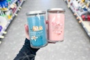 person holding 2 yankee candles