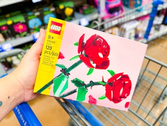 hand holding a Lego roses building set