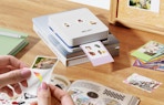 a photo printer printing photos on a table 