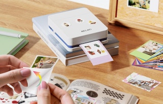 a photo printer printing photos on a table 