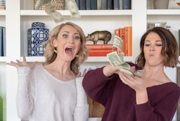 Two people throwing cash around.