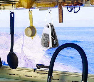 mini kitchen tools on a keyring hanging on a hook in a kitchen