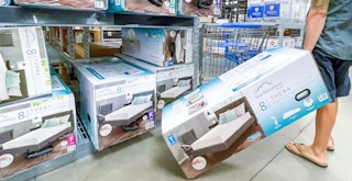 best cheap mattress - A man taking a boxed mattress from a shelf at Walmart