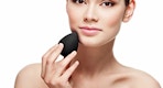 a person using a beauty blender on their face