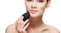 a person using a beauty blender on their face