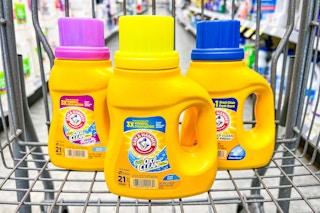 three bottles of laundry detergent in shopping cart
