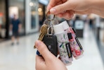 a woman holding a keyring