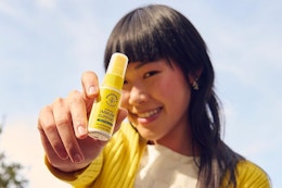 a woman holding immune support spray