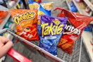 cheetos, takis, lays, and doritos in a cart