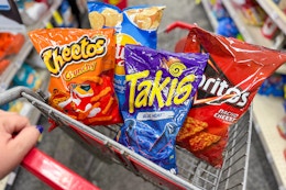 cheetos, takis, lays, and doritos in a cart